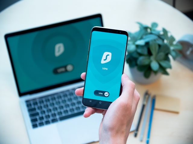 Free VPN vs premium VPN: the same app on a phone and laptop, but the experience behind it is very different VPN app connected on a smartphone next to a laptop running the same VPN