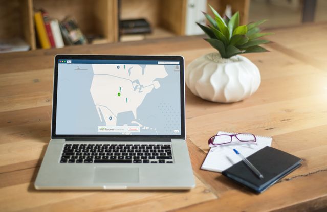 Laptop displaying location routing interface on a desk