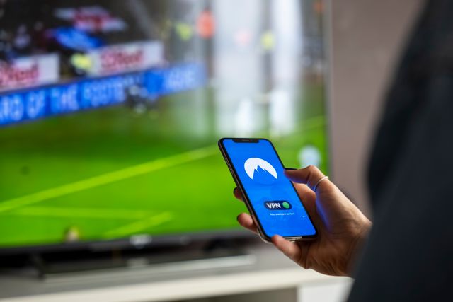 VPN app connected on a phone in front of a television